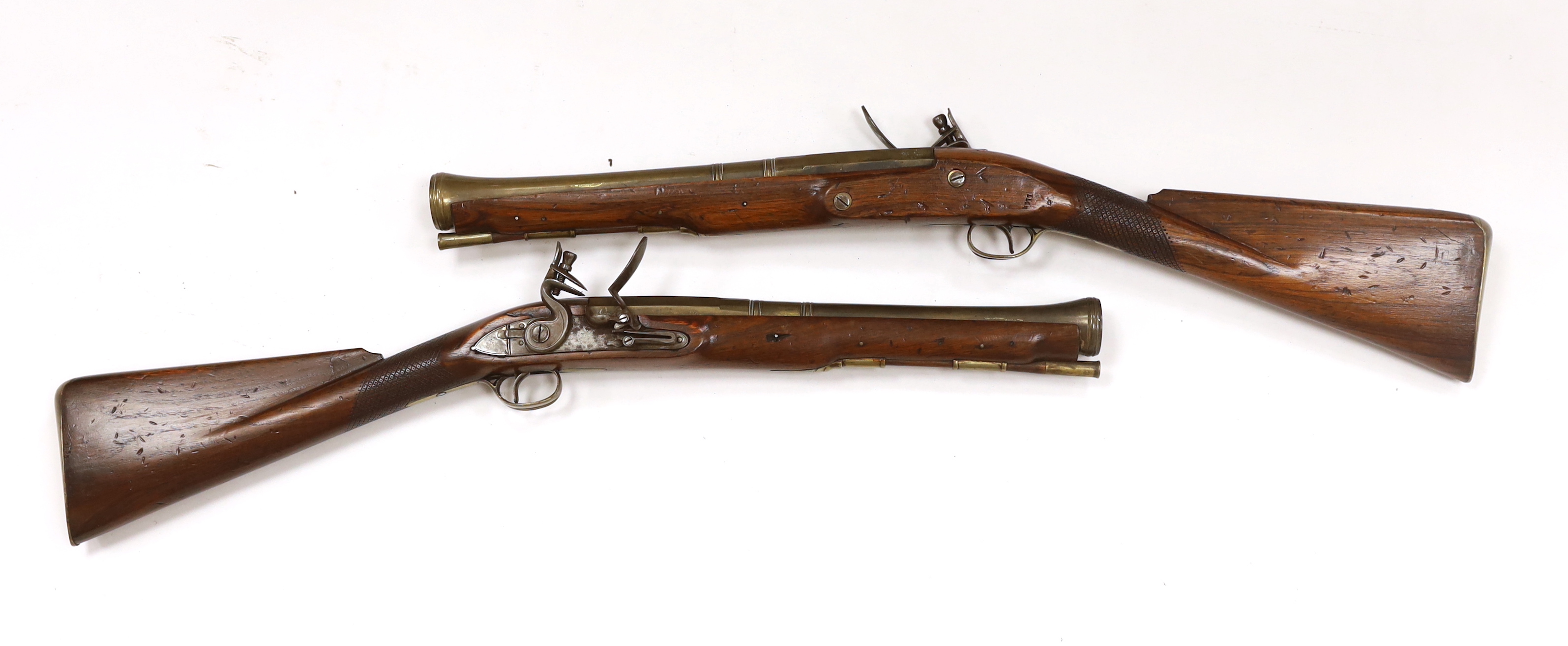 A pair of reproduction 'York Mail' flintlock blunderbusses in a late 18th century style.